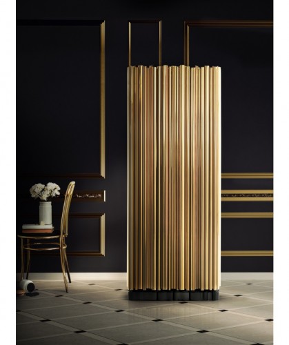 This is Symphony, a cabinet made from wood finished covered by a tubular structure in gold plated brass.